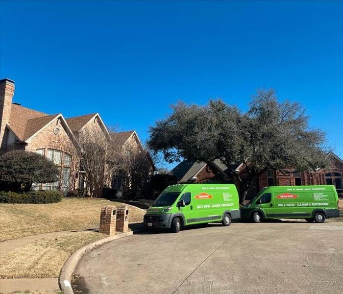 two SERVPRO vans in residential area