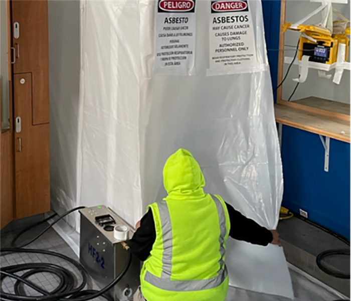 worker setting up decontamination chamber